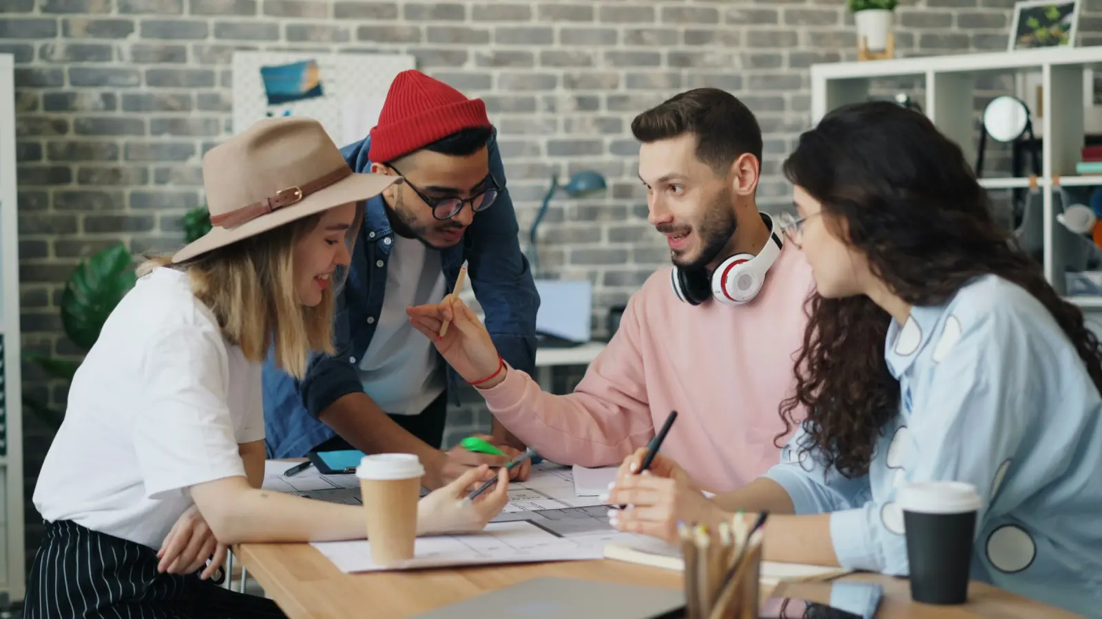 A creative team working together around a wooden table